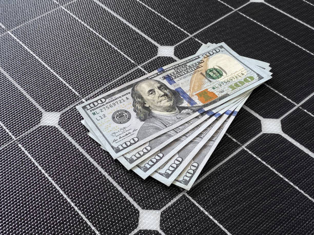100 dollar bills on a solar cell panel